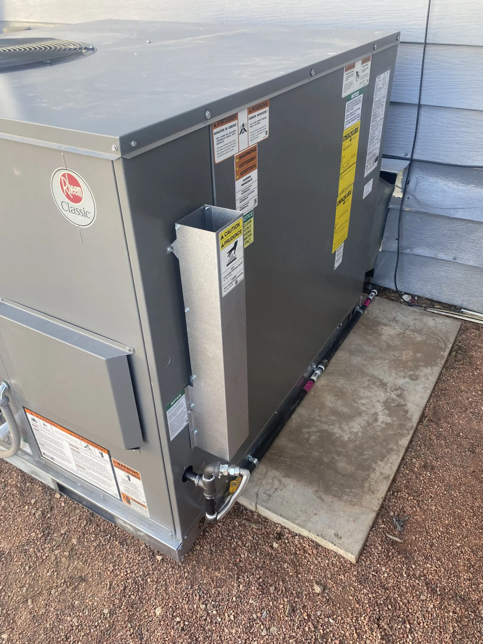 A large air conditioner unit sitting outside of a house.