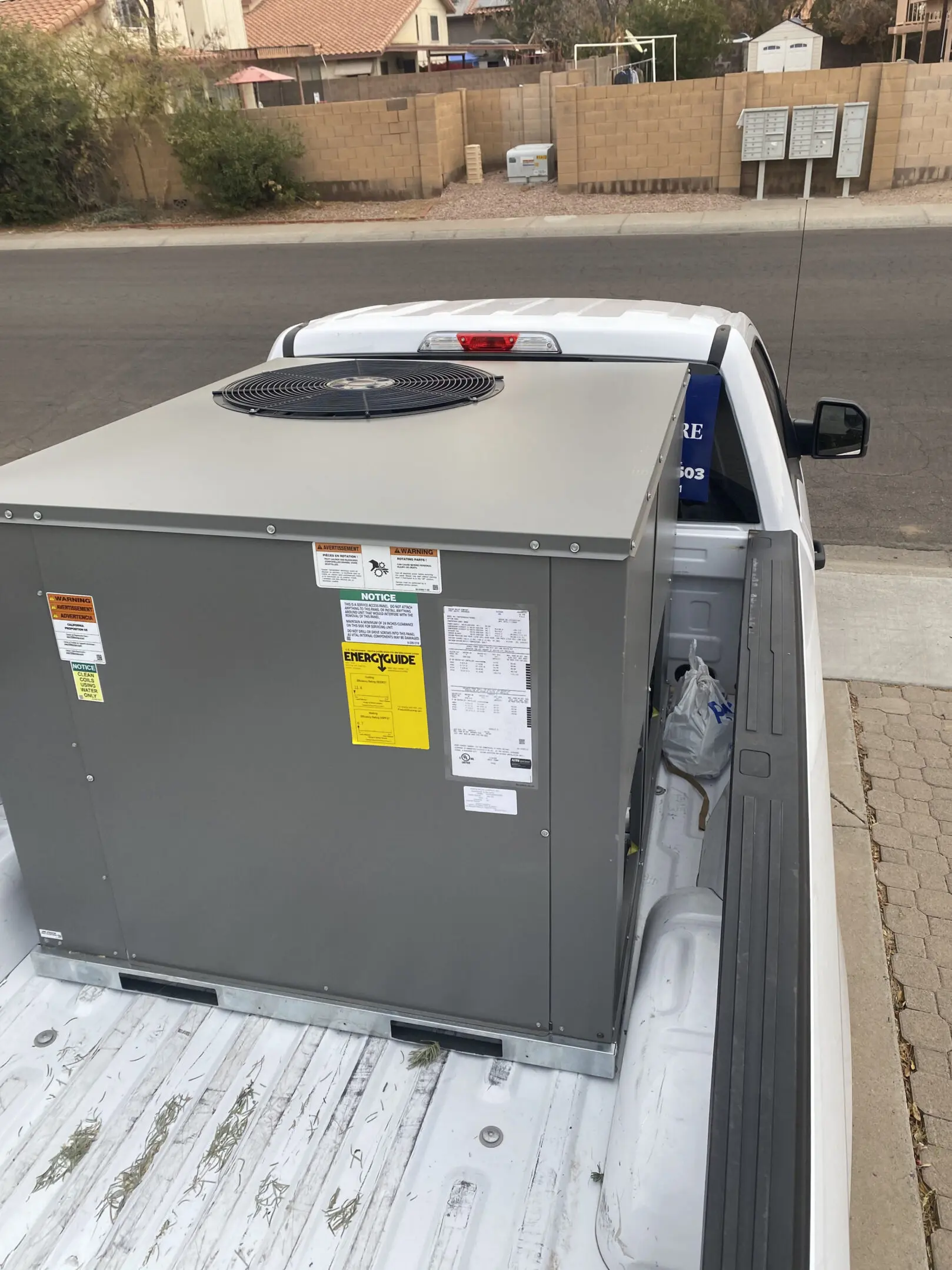 A truck with an air conditioner unit in the back.