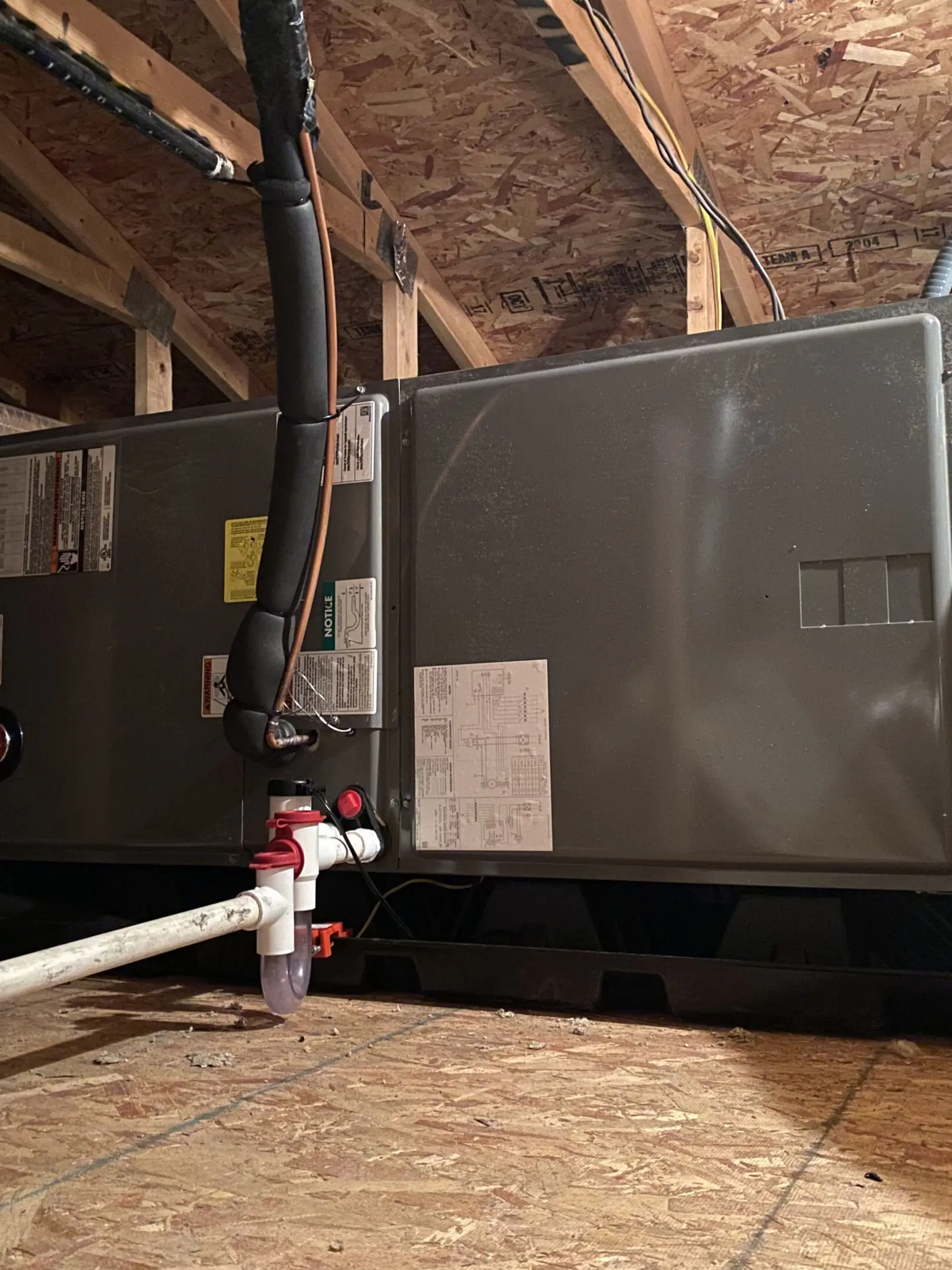 A gray air conditioner sitting in the middle of a room.