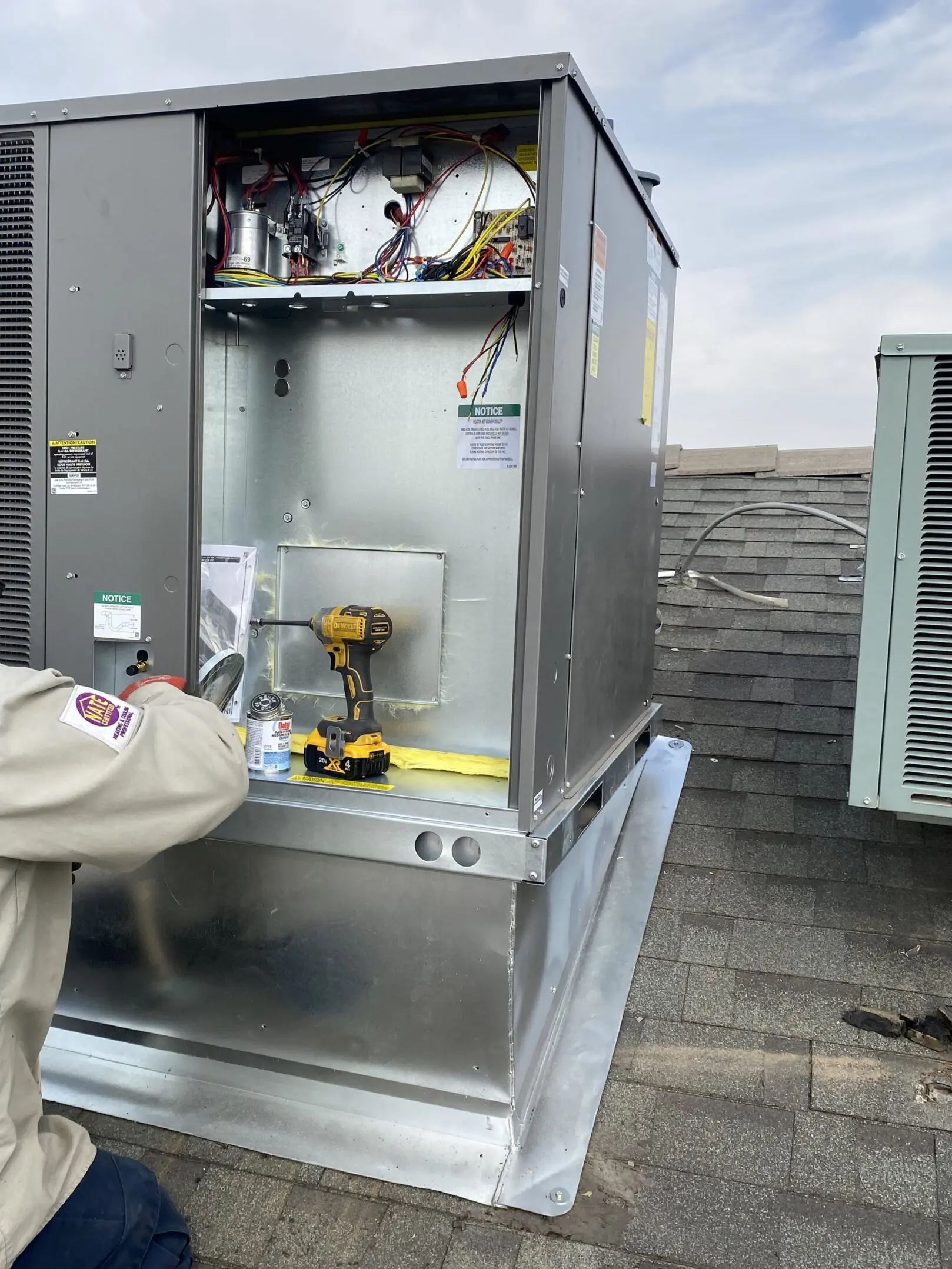 A man is working on an air conditioner unit.