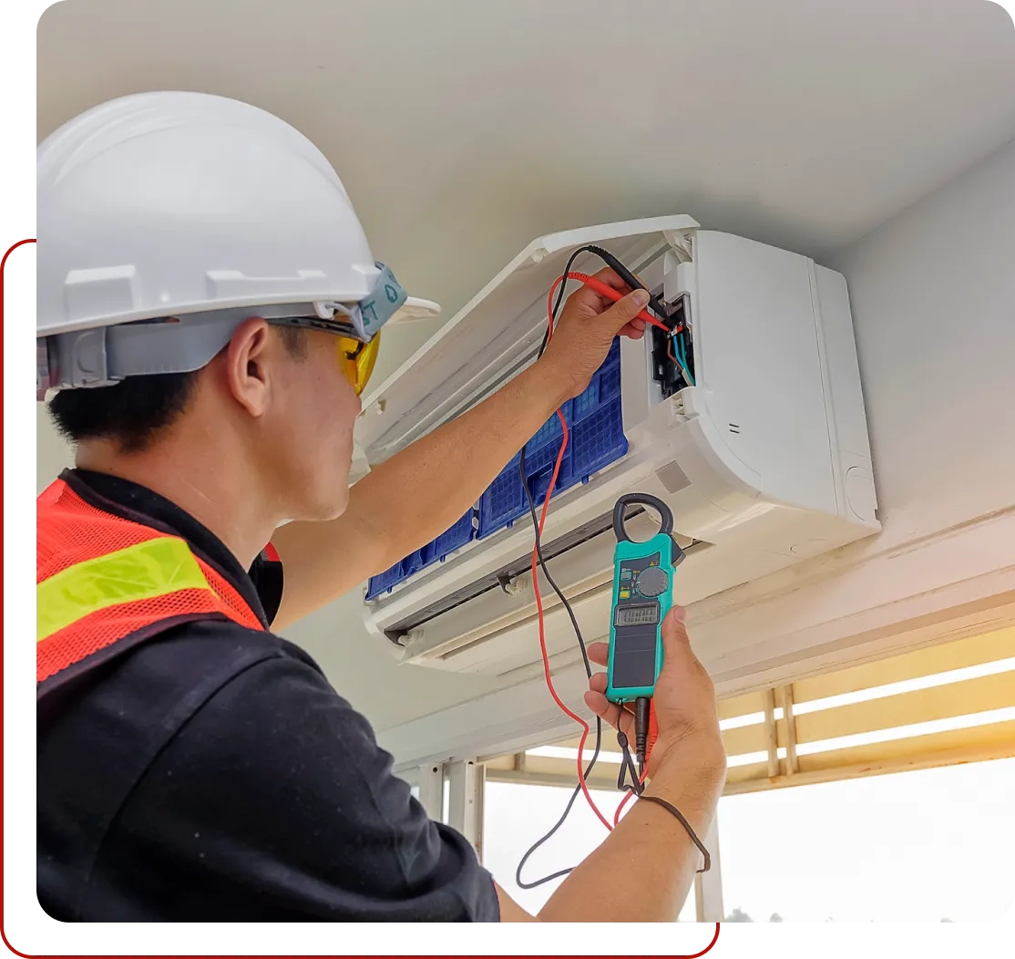 A technician in protective gear checks an air conditioning unit with a multimeter, inspecting its electrical components. Trust our affordable HVAC services for reliable maintenance that ensures your system runs efficiently and safely.