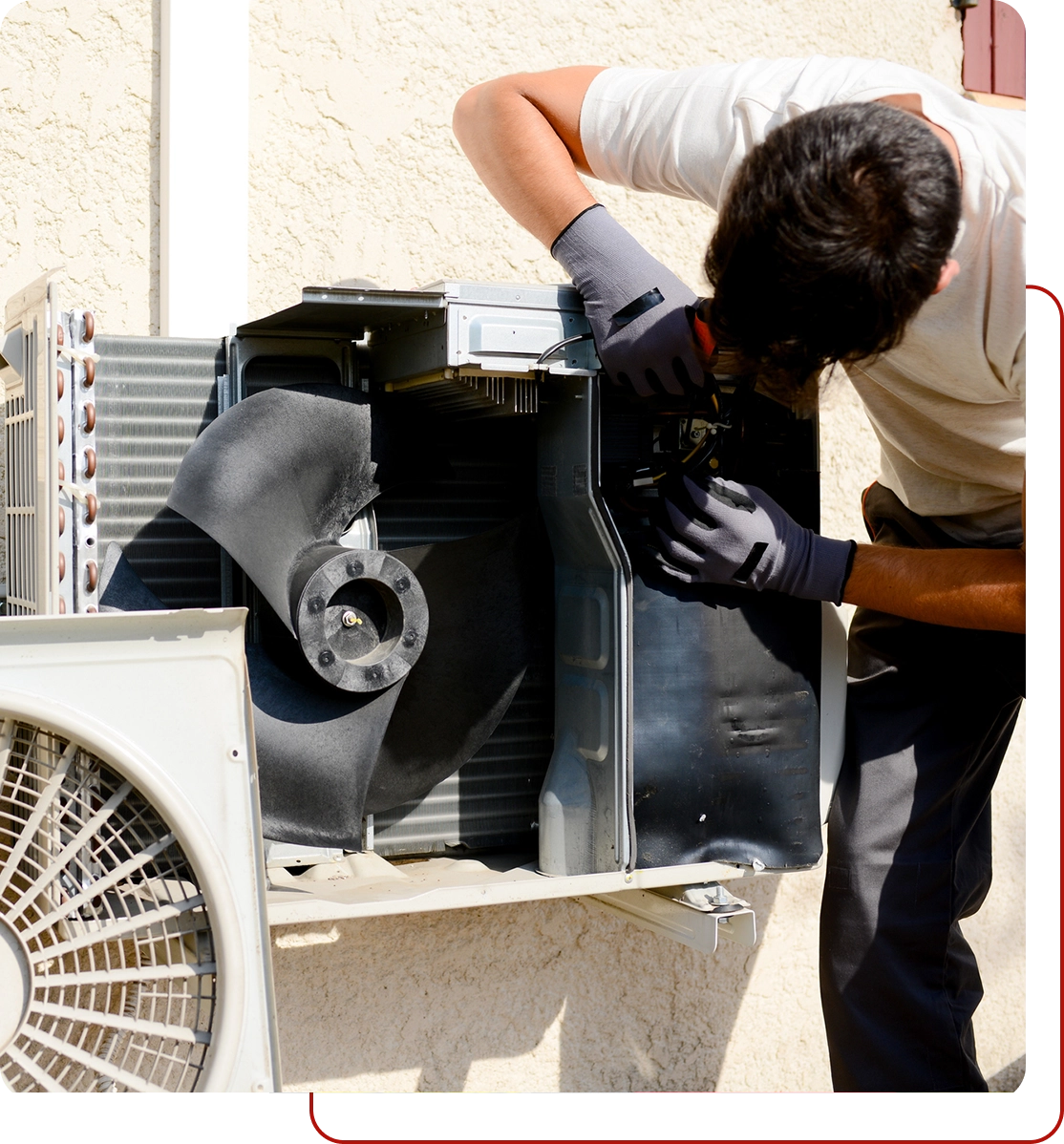 A technician from Affordable HVAC Services skillfully works on an air conditioning unit outside, wearing gloves and adjusting the internal components with precision.